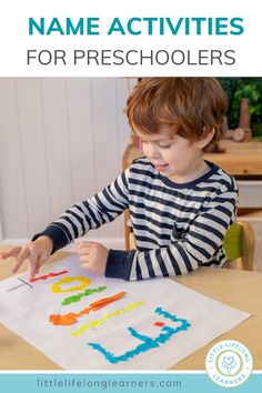 a young boy sitting at a table with his hands in the air and writing name activities for preschoolers