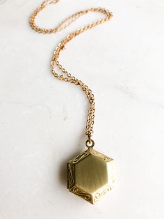 "Tiny hexagon locket This small gold hexagon locket is the perfect size to wear close to your heart or long. It's subtle style is classic and has a great vintage feel. Choose the length and style of chain (select options upon checkout) The model photo shows a 16\" Chain in the photo is antique gold I can even add a special message for you! ADD the PERSONALISED LOCKET MESSAGE listing https://www.etsy.com/ca/listing/521595673/personalise-your-locket-purchase-add-a to have a special message placed Dainty Brass Locket Necklace, Gold Octagon Necklace For Wedding, Minimalist Gold Locket Necklace, Vintage Gold Octagon Jewelry, Vintage Octagon Gold Jewelry, Tiny Locket, Antique Gold Locket, Fern Moss, Nature Fairy