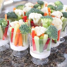 small cups filled with veggies on top of a counter