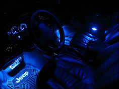 the interior of a car is lit up with blue lights