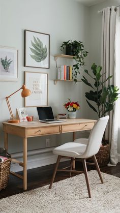 a desk with a laptop computer on top of it next to a potted plant