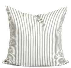 a white and grey striped pillow on a white background