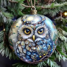 an owl ornament hanging from a christmas tree