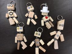 several wooden keychains are arranged in the shape of people