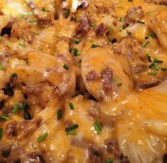 a close up view of a cheesy dish with meat and cheese on it