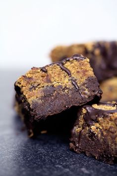 chocolate chip cookie bars stacked on top of each other with one cut in half to show the filling