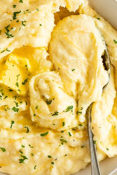 mashed potatoes in a white bowl with a spoon