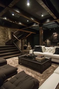 a living room filled with furniture and a stair case in the middle of the room