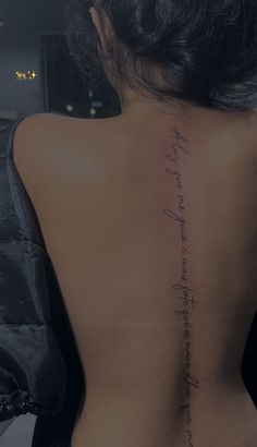 the back of a woman's body with writing on her lower back and upper back