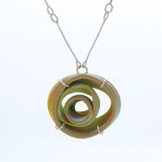 Silver Necklace - This hand-thrown porcelain necklace is crafted with care and precision by artist Lynn Latta. She combines and forms the pieces, then kiln-fires them to achieve vitrification. The glazes are a combination of hand painted and sprayed, and traditional metalsmithing techniques are used to set the pieces in sterling silver. Hook clasp closure. Contemporary Pendant Necklace For Gift, Artisan Hand Cast Necklace With Round Pendant, Artisan Necklace With Round Pendant, Unique Handmade Ceramic Jewelry, Contemporary Necklace With Unique Design For Gift, Hand Forged Green Necklace In Nature-inspired Style, Nature-inspired Hand Forged Green Necklace, Modern Green Necklace With Round Pendant, Modern Green Round Pendant Necklace