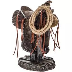 a statue of a horse with rope around it's neck and boots on its back