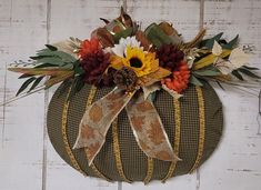 a decorative pumpkin decorated with flowers and leaves