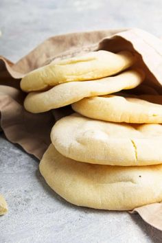 a pile of uncooked bread sitting on top of a table