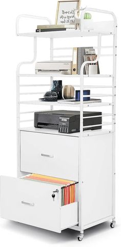 a white file cabinet with two drawers and a shelf above it that has files on top