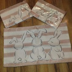 three bunny napkins sitting on top of a wooden floor