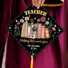 a person wearing a graduation cap that reads teacher helping little minds grow with flowers on it