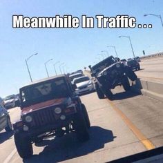 there are many jeeps driving on the highway together in traffic, and one is off road