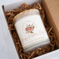 an open gift box with a candle in it