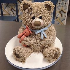 a teddy bear sitting on top of a white plate