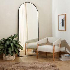 a chair and mirror in a room with a rug on the floor next to it