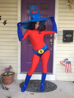 a woman in a red and blue costume is standing on the front porch with her hands behind her head