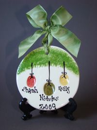 a ceramic ornament with the names of three babies