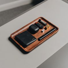 a wooden tray with various items on it