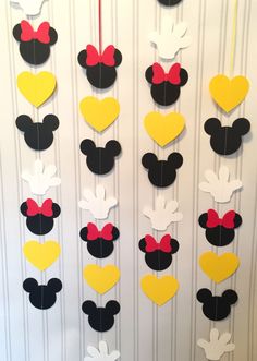 mickey and minnie mouse party decorations hanging on the wall with hearts shaped like heart shapes