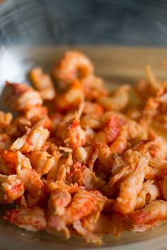 a bowl filled with pasta and sauce on top of a table