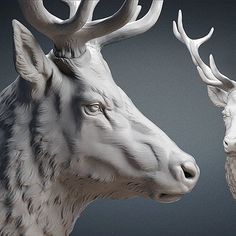 two white deer statues with antlers on their heads, one looking at the other