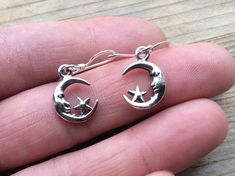 MOON and STAR 925 silver earrings small 1.5cm divine celestial light companionship beautiful sleek gift love friendship Symbolism: The moon is a feminine symbol, universally representing the rhythm of time as it embodies the cycle. The phases of the moon symbolise immortality and eternity, enlightenment or the dark side of Nature herself. According to some Pagan traditions the five pointed star is the four elements of Earth, Fire, Water, and Air with an added human element of spirit. Its five po Champagne Ring, Blue Aura Quartz, Feminine Symbols, Cotton Gift Bag, Green Belt, Five Pointed Star, Gift Love, Moon And Star, 925 Silver Earrings