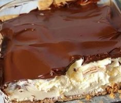 a close up of a pie in a pan with chocolate and marshmallows