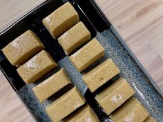 several squares of food sitting on top of a pan