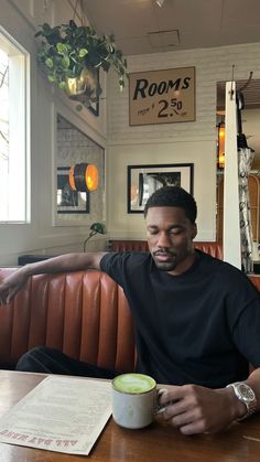 a man sitting at a table with a coffee cup