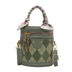 Introducing our Chic Geometric Quilted Handbag, a perfect blend of style and practicality for the modern woman on the go. This handbag features a unique geometric quilted design that adds a touch of sophistication and texture to the overall look. The soft sage green color is versatile and on-trend, ensuring that this bag will complement a wide range of outfits, from casual to formal.Attention to detail is evident in the design, with a decorative scarf tied around the handle, adding a playful and feminine touch. The bag is accented with gold-tone hardware, including a charm and zipper, which not only enhances its elegance but also offers durability. The compact size is ideal for carrying essentials without the bulk, making it a great choice for day-to-day use or special occasions.Functional Trendy Green Bucket Bag With Zipper Closure, Green Quilted Square Bag, Square Green Quilted Bag, Trendy Green Quilted Shoulder Bag, Trendy Quilted Shopping Bags, Chic Quilted Square Bag, Green Bucket Bag With Zipper Closure, Trendy Top Handle Bucket Bag With Zipper Closure, Trendy Quilted Leather Bag