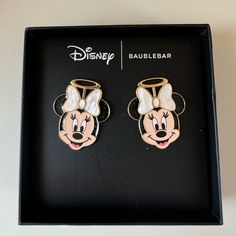 two mickey mouse earrings in a box