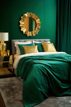 a bedroom with green walls and gold accents