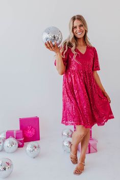 Shine brighter than the Christmas tree in THE ALL THAT SHIMMERS SEQUIN DRESS IN MAGENTA BY PINK DESERT. This shimmering magenta sequin number boasts pink sequins, short puff sleeves, and a flattering V-neck. It's exclusive to Pink Desert and guaranteed to make your holidays more sparkly (in the best possible way). Mage Pink V-neck Mini Dress With Sequins, Holiday Sequin Dress With Contrast Sequins For Festive Occasion, Festive Mini Sequin Dress, Pink Holiday Dress For Christmas Party, Festive Glitter Dresses For Party Season, Festive Sequin Dresses For Party Season, Contrast Sequin Festive Dress For Party Season, Festive Party-ready Sequin Dress, Festive Glitter Dress