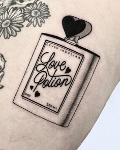 a woman's thigh with a tattoo on it that reads love station and flowers