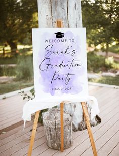 a welcome sign on an easel for graduation party