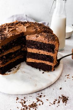 a chocolate cake with one slice cut from it