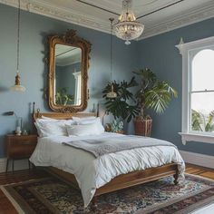 a bed sitting in a bedroom next to a window with a large mirror on the wall