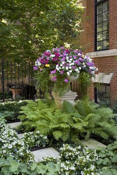 a large vase filled with lots of flowers sitting on top of a lush green field