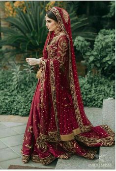 a woman in a red and gold bridal gown