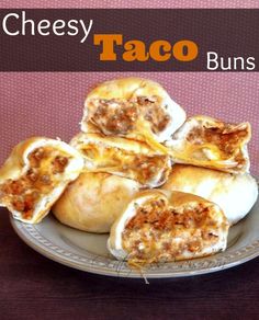 cheesey taco buns on a plate with text overlay that reads cheesy taco buns