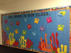 a bulletin board with sea animals and corals painted on it's sides in a classroom