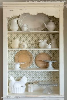 a china cabinet with plates and dishes on it