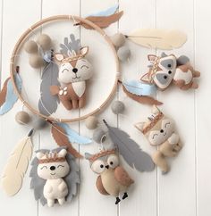 an animal themed dream catcher hanging on a white wooden wall next to a stuffed bear