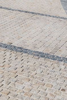 a man riding a skateboard down a brick sidewalk