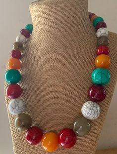 This Long Handbeaded Necklace is made with multicoloured resin beads; The colours are; Mango Orange, Red Crackle, Natural grey, White crackle, Turquoise, Maroon.  The beads vary in size, the largest at the centre of the necklace and taper to the screw fastening. The screw fastening is integrated inside the bead. No metal touches the skin. Measurements: Length: 66 cm. Largest Bead: 2.5 cm. Smallest bead: 1 cm. HANDMADE & FAIRTRADE Your necklace will be dispatched by Royal Mail 1st Class UK Standa Handmade Resin Necklaces With Round Beads, Colorful Round Beaded Resin Jewelry, Multicolor Resin Bead Jewelry, Multicolor Polished Bead Round Necklace, Colorful Vibrant Beaded Necklace With Round Beads, Multicolor Wooden Beads Jewelry, Multicolor Wooden Round Beads Jewelry, Multicolor Wooden Beaded Jewelry, Multicolor Round Beads With Natural Stones